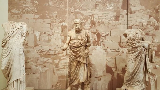 Socrates Three ancient statues on a textured background depicting historical figures.